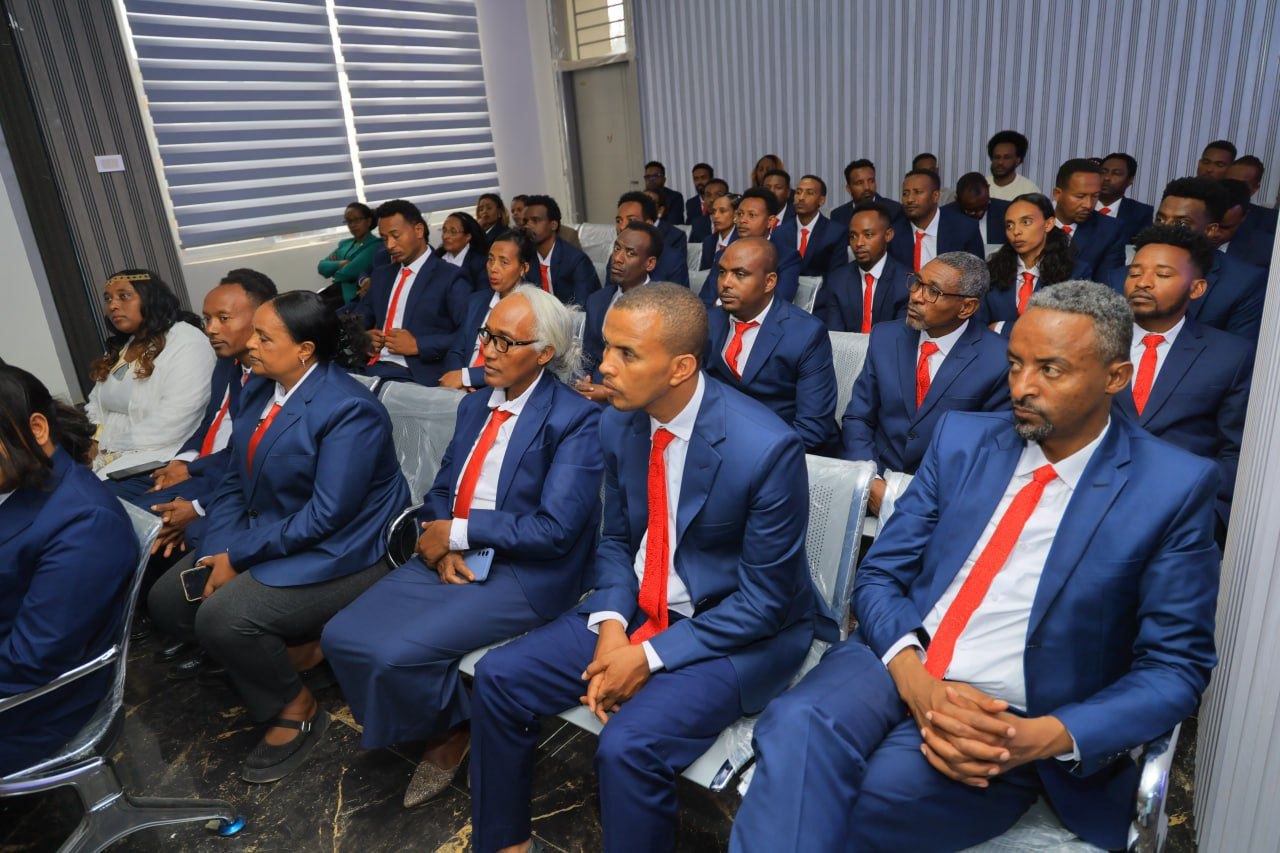 Staff and guests seated at the opening event.